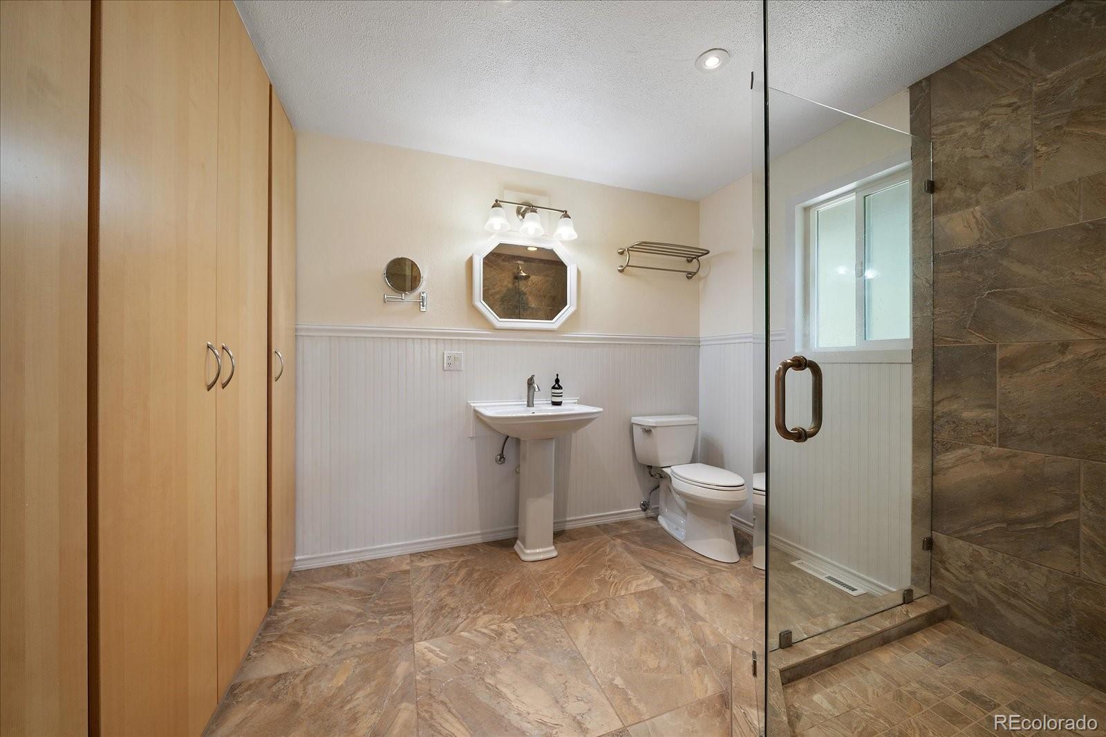 4039 Histead Way Evergreen, CO 80439 - Photo 31 of 48 a bathroom with a sink and a mirror
