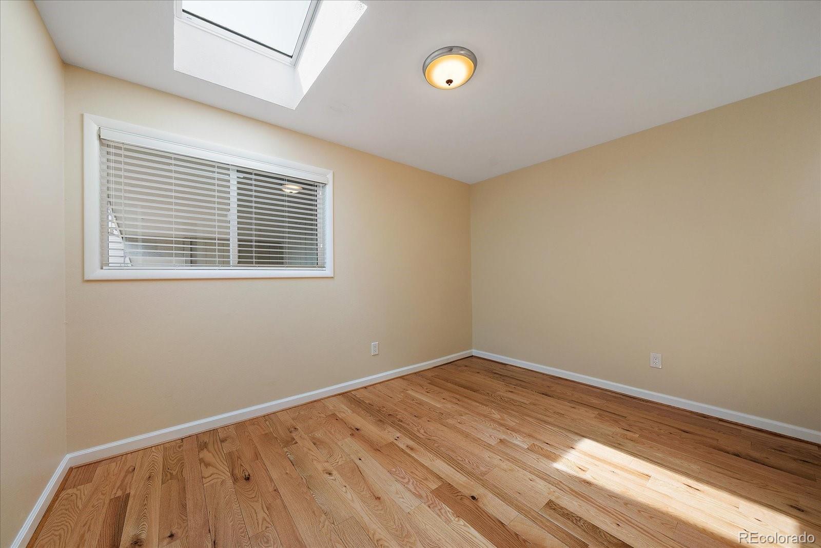4039 Histead Way Evergreen, CO 80439 - Photo 34 of 48 a view of an empty room with wooden floor and a window