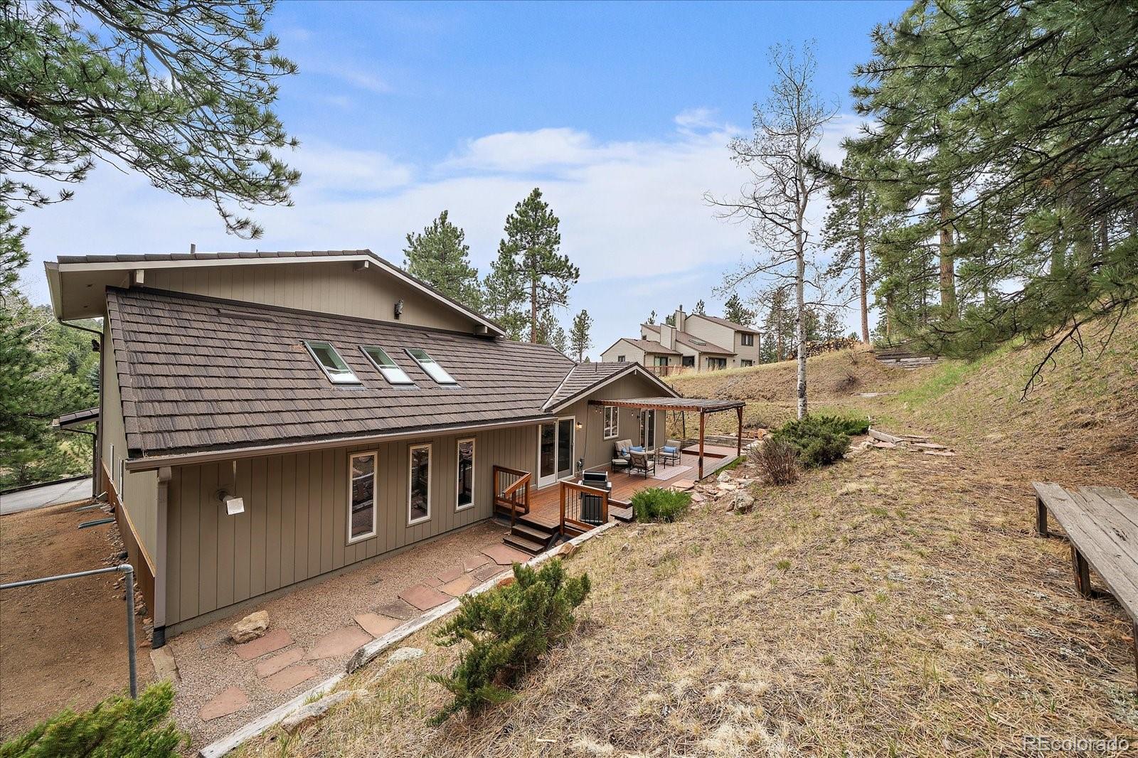 4039 Histead Way Evergreen, CO 80439 - Photo 40 of 48 a front view of a house with a yard