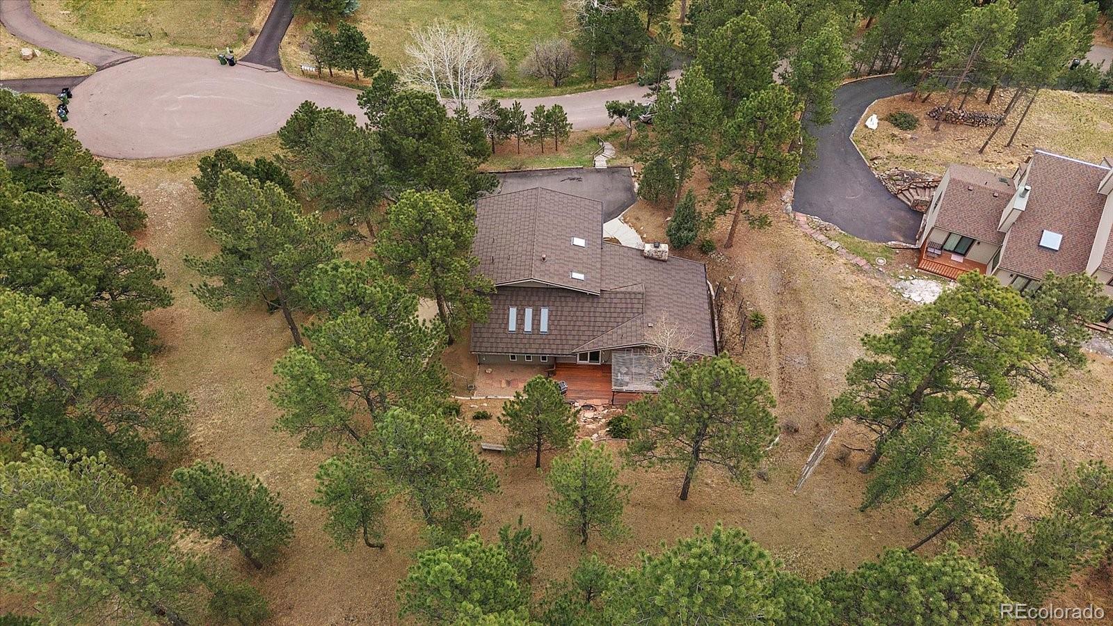 4039 Histead Way Evergreen, CO 80439 - Photo 43 of 48 an aerial view of a house with outdoor space and a lake view