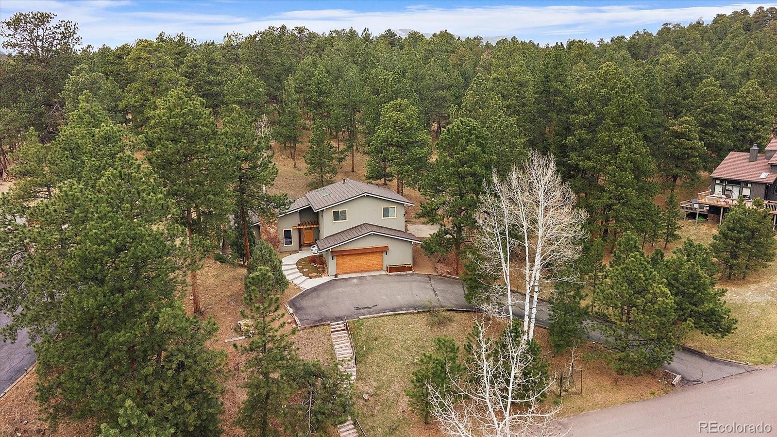 4039 Histead Way Evergreen, CO 80439 - Photo 45 of 48 an aerial view of a house with a yard