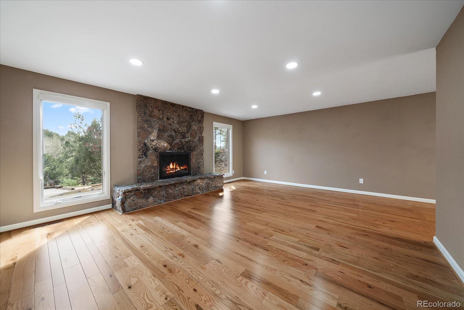 4039 Histead Way Evergreen, CO 80439 - Photo 7 of 48 a view of an empty room with wooden floor and a window