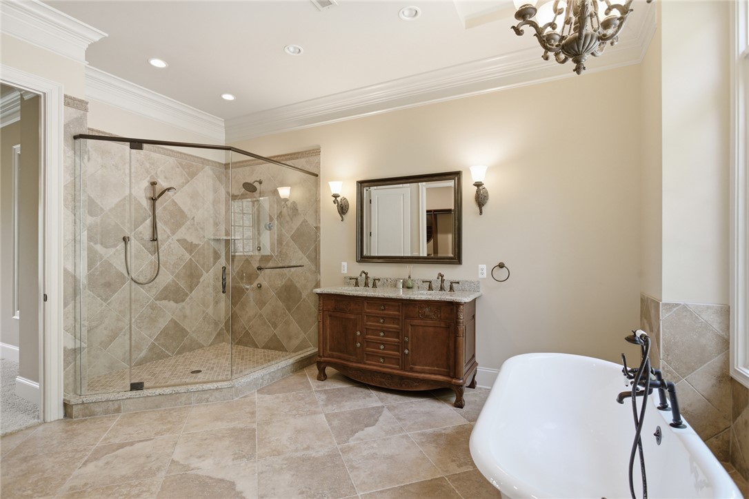 130 River Ridge Road Sunset, SC 29685 - Photo 17 of 47 This primary bathroom features a generous glass-enclosed shower, a double vanity, and a freestanding soaking tub.