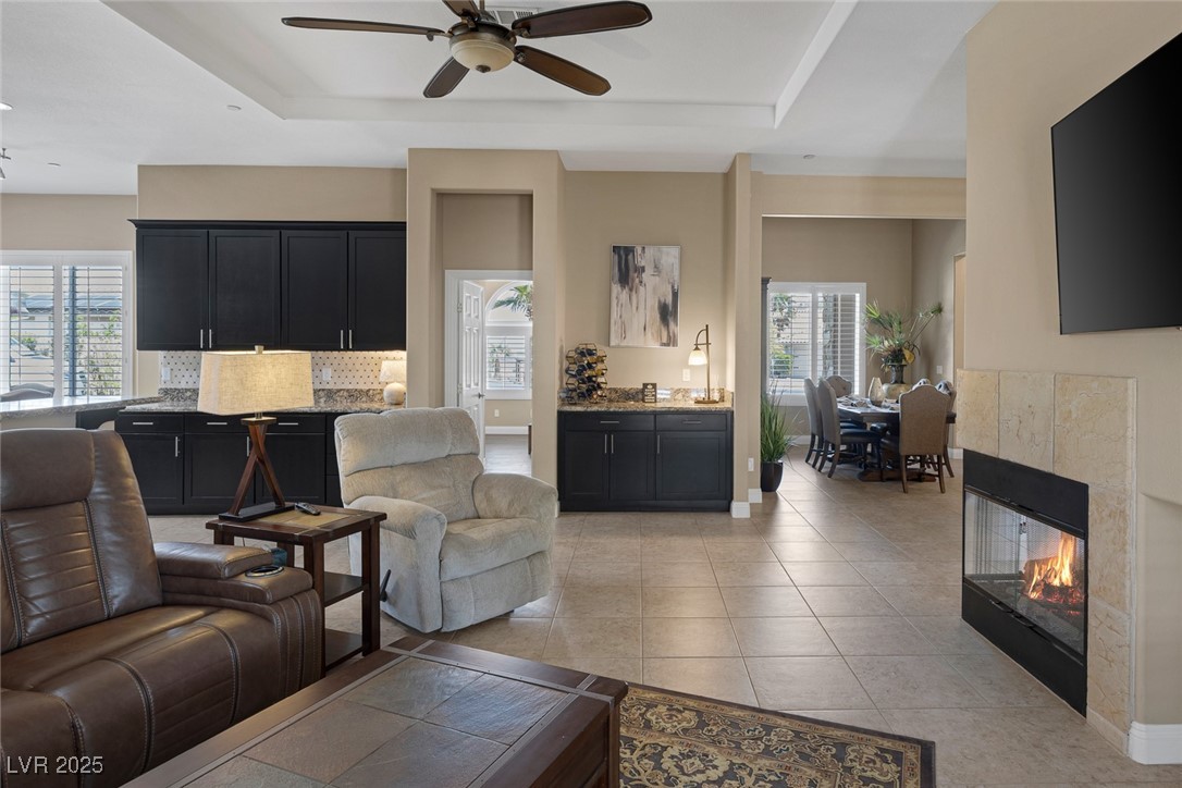 7687 West Pebble Road Las Vegas, NV 89113 - Photo 12 of 79 Living area featuring ceiling fan, baseboards, and light tile patterned floors