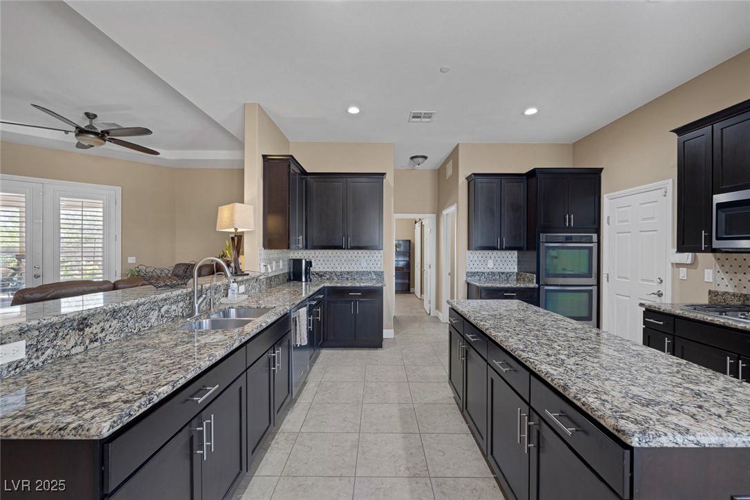 7687 West Pebble Road Las Vegas, NV 89113 - Photo 18 of 79 Kitchen featuring a ceiling fan, visible vents, a center island, a sink, and stainless steel appliances
