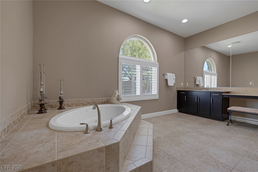 7687 West Pebble Road Las Vegas, NV 89113 - Photo 29 of 79 Full bathroom with visible vents, recessed lighting, vanity, tile patterned flooring, and a garden tub