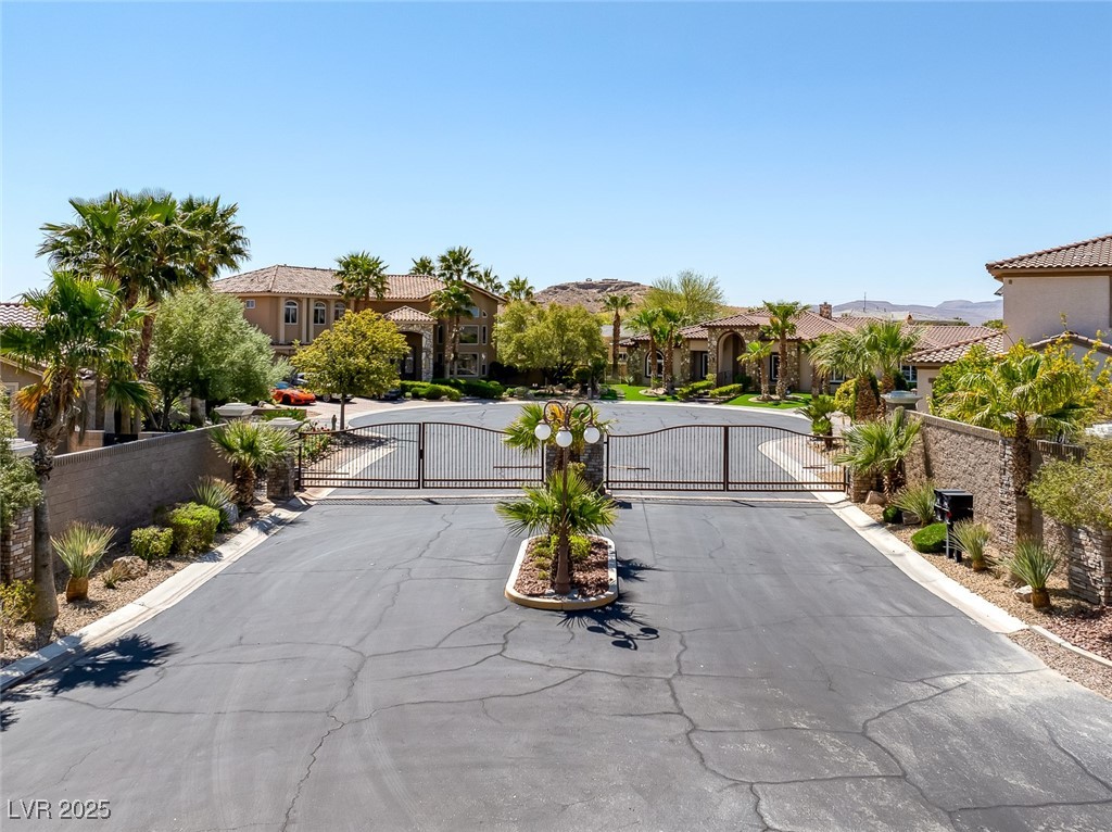 7687 West Pebble Road Las Vegas, NV 89113 - Photo 3 of 79 View of road with a residential view, a gated entry, curbs, and a gate