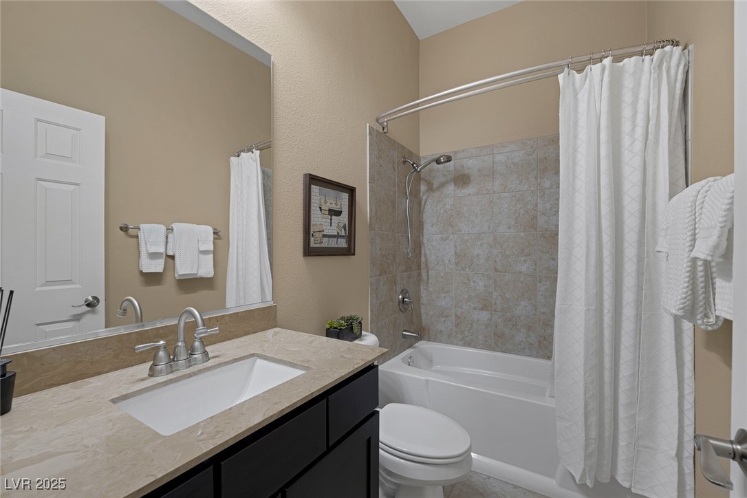 7687 West Pebble Road Las Vegas, NV 89113 - Photo 34 of 79 Full bathroom featuring toilet, shower / bath combo with shower curtain, and vanity