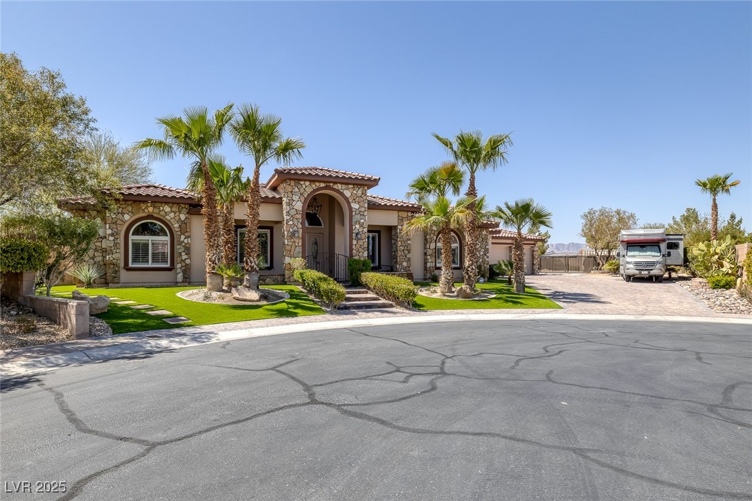 7687 West Pebble Road Las Vegas, NV 89113 - Photo 35 of 79 Mediterranean / spanish home featuring stucco siding, stone siding, decorative driveway, and a tile roof