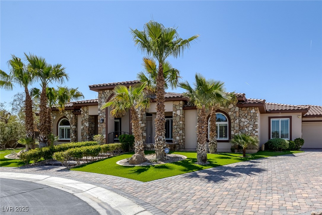 7687 West Pebble Road Las Vegas, NV 89113 - Photo 36 of 79 Mediterranean / spanish home featuring a tiled roof, stucco siding, and stone siding