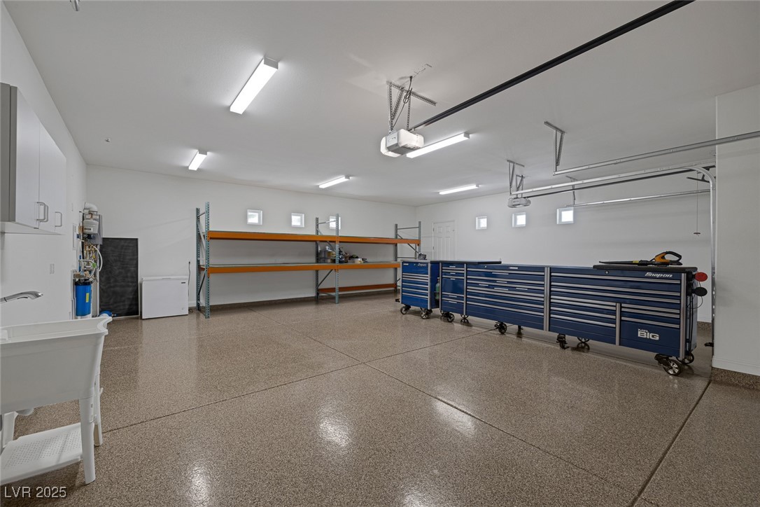 7687 West Pebble Road Las Vegas, NV 89113 - Photo 38 of 79 Garage featuring baseboards and a garage door opener