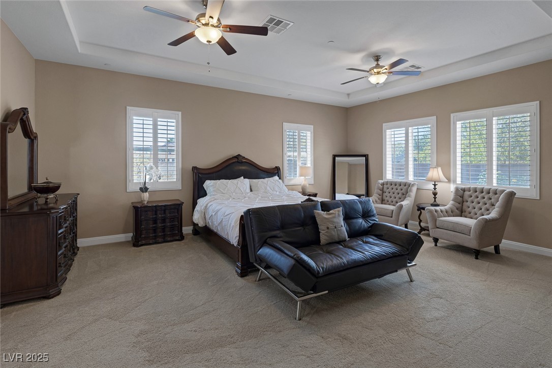 7687 West Pebble Road Las Vegas, NV 89113 - Photo 48 of 79 Bedroom featuring visible vents, light colored carpet, and multiple windows