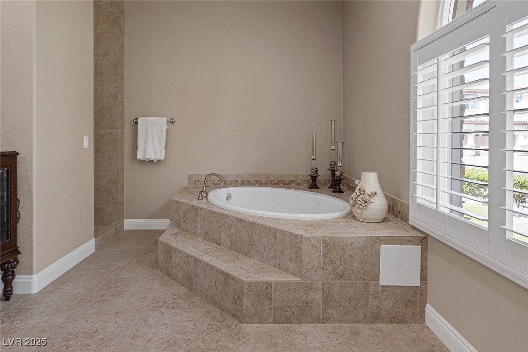 7687 West Pebble Road Las Vegas, NV 89113 - Photo 51 of 79 Bathroom with a bath, tile patterned flooring, and baseboards