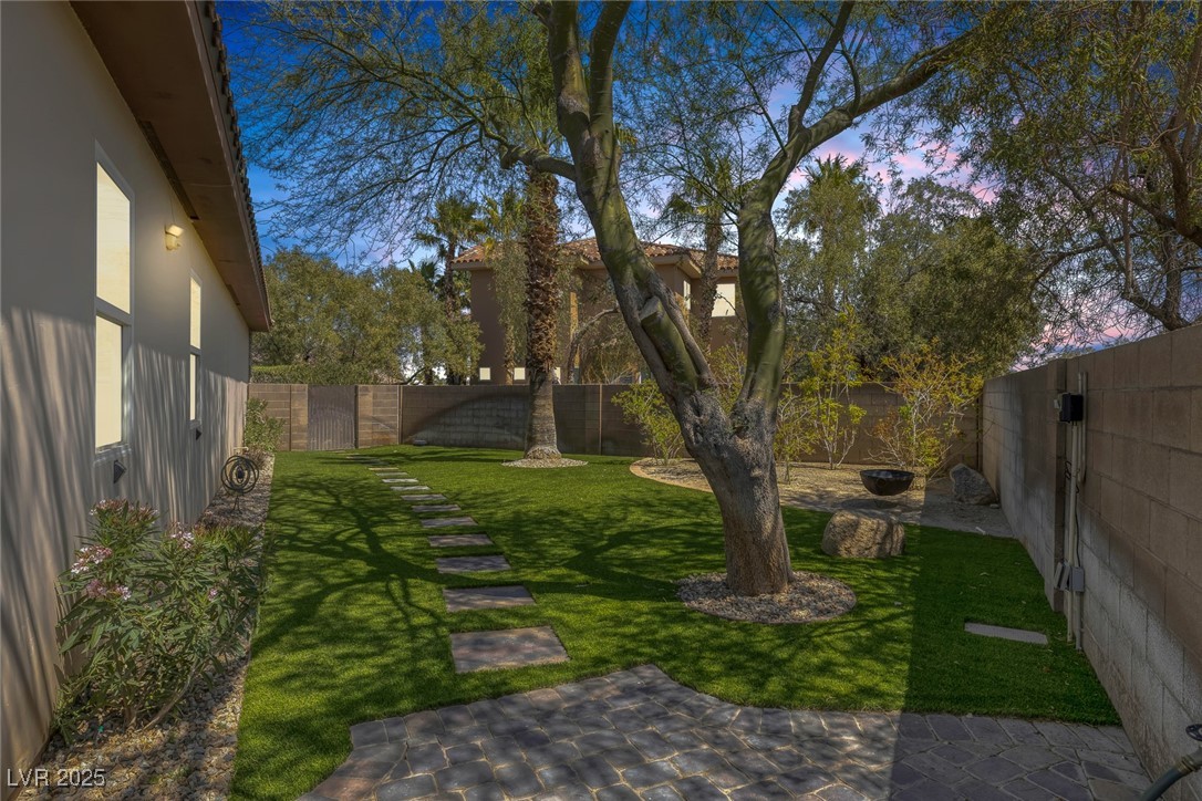 7687 West Pebble Road Las Vegas, NV 89113 - Photo 57 of 79 Yard at dusk with a fenced backyard