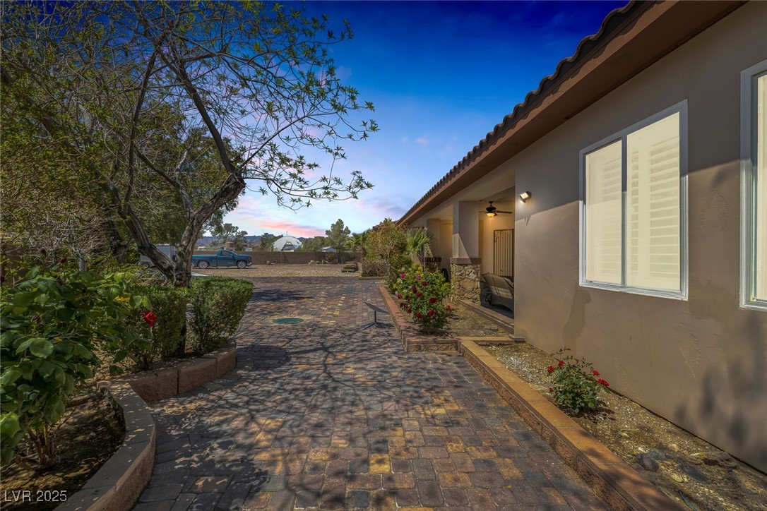 7687 West Pebble Road Las Vegas, NV 89113 - Photo 58 of 79 View of home's exterior featuring a patio, stucco siding, and a tile roof