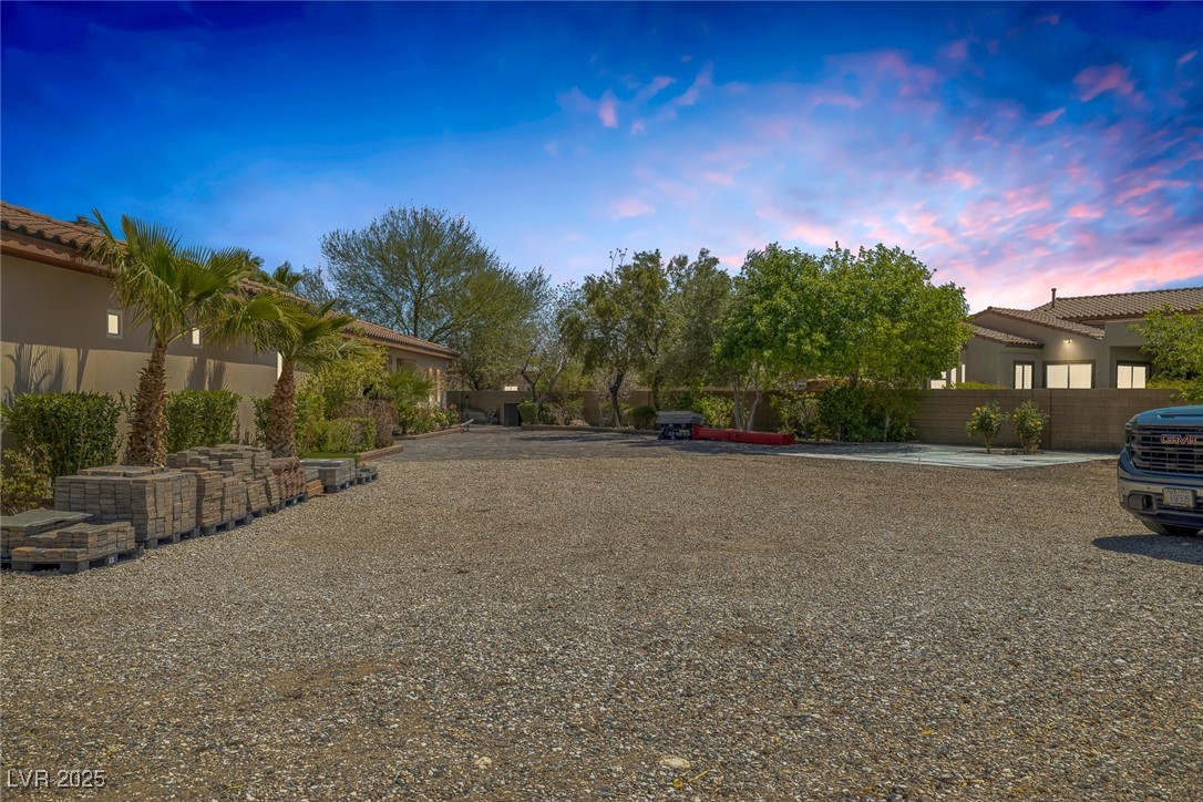 7687 West Pebble Road Las Vegas, NV 89113 - Photo 6 of 79 Yard at dusk featuring fence