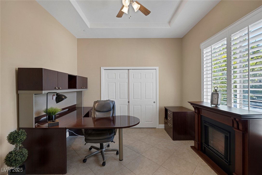 7687 West Pebble Road Las Vegas, NV 89113 - Photo 61 of 79 Office area with light tile patterned flooring, ceiling fan, and a tray ceiling