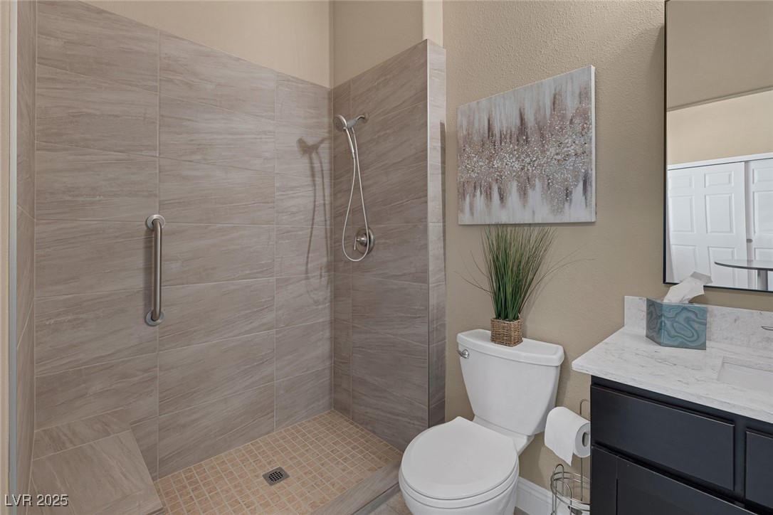 7687 West Pebble Road Las Vegas, NV 89113 - Photo 62 of 79 Full bathroom with toilet, tiled shower, and vanity