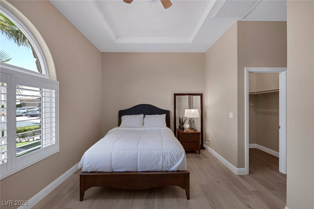 7687 West Pebble Road Las Vegas, NV 89113 - Photo 63 of 79 Bedroom featuring light wood-style floors, visible vents, and multiple windows