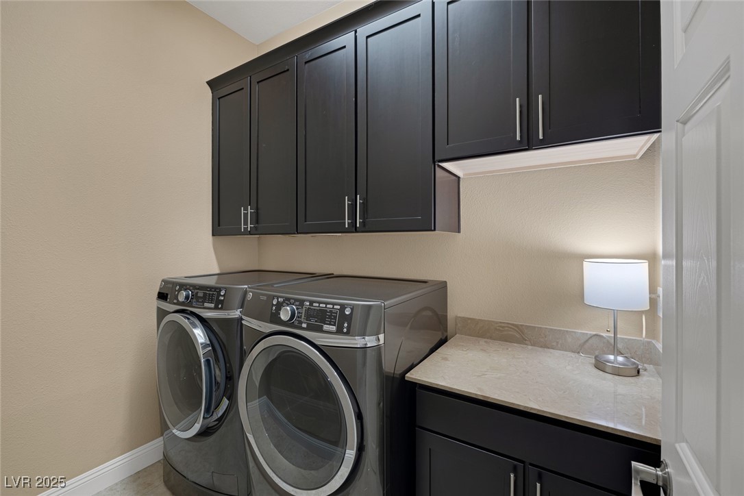 7687 West Pebble Road Las Vegas, NV 89113 - Photo 64 of 79 Laundry room featuring separate washer and dryer, baseboards, and cabinet space