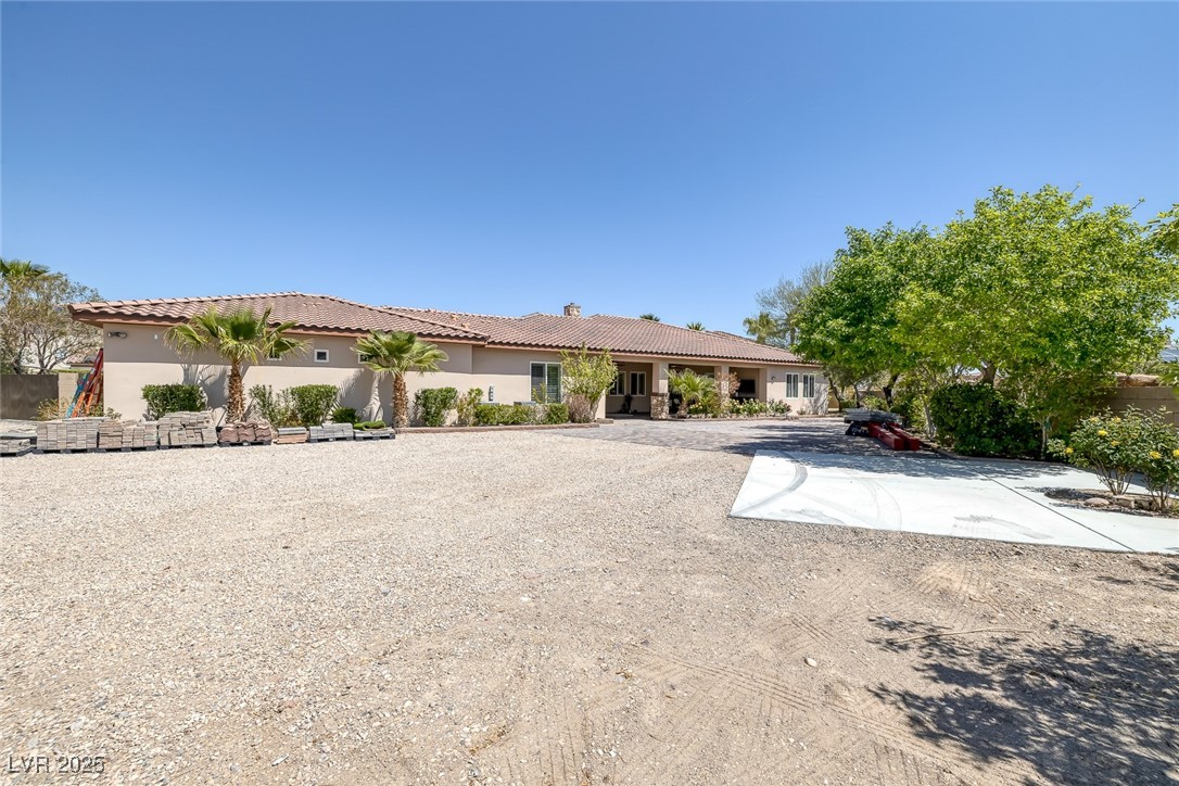 7687 West Pebble Road Las Vegas, NV 89113 - Photo 68 of 79 View of front of house featuring a tile roof and stucco siding
