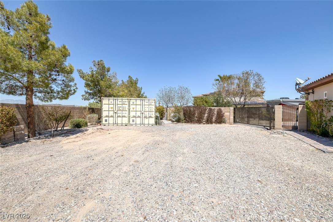 7687 West Pebble Road Las Vegas, NV 89113 - Photo 71 of 79 View of yard featuring fence, mail area, and a gate