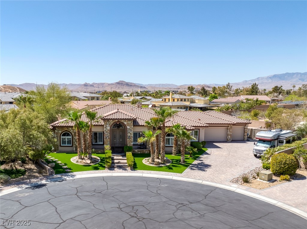 7687 West Pebble Road Las Vegas, NV 89113 - Photo 73 of 79 Mediterranean / spanish-style home featuring a mountain view, a garage, a tile roof, and decorative driveway