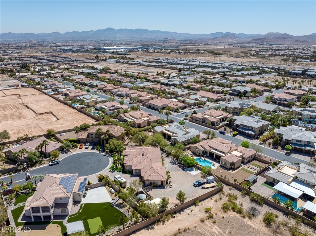 7687 West Pebble Road Las Vegas, NV 89113 - Photo 78 of 79 Drone / aerial view featuring a mountain view and a residential view