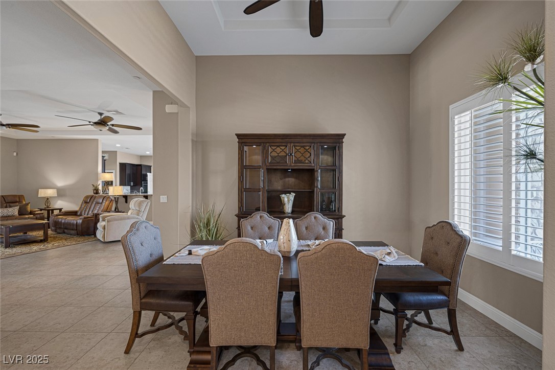 7687 West Pebble Road Las Vegas, NV 89113 - Photo 9 of 79 Dining room with ceiling fan, baseboards, and light tile patterned floors