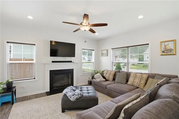 a dining room with furniture a chandelier and wooden floor