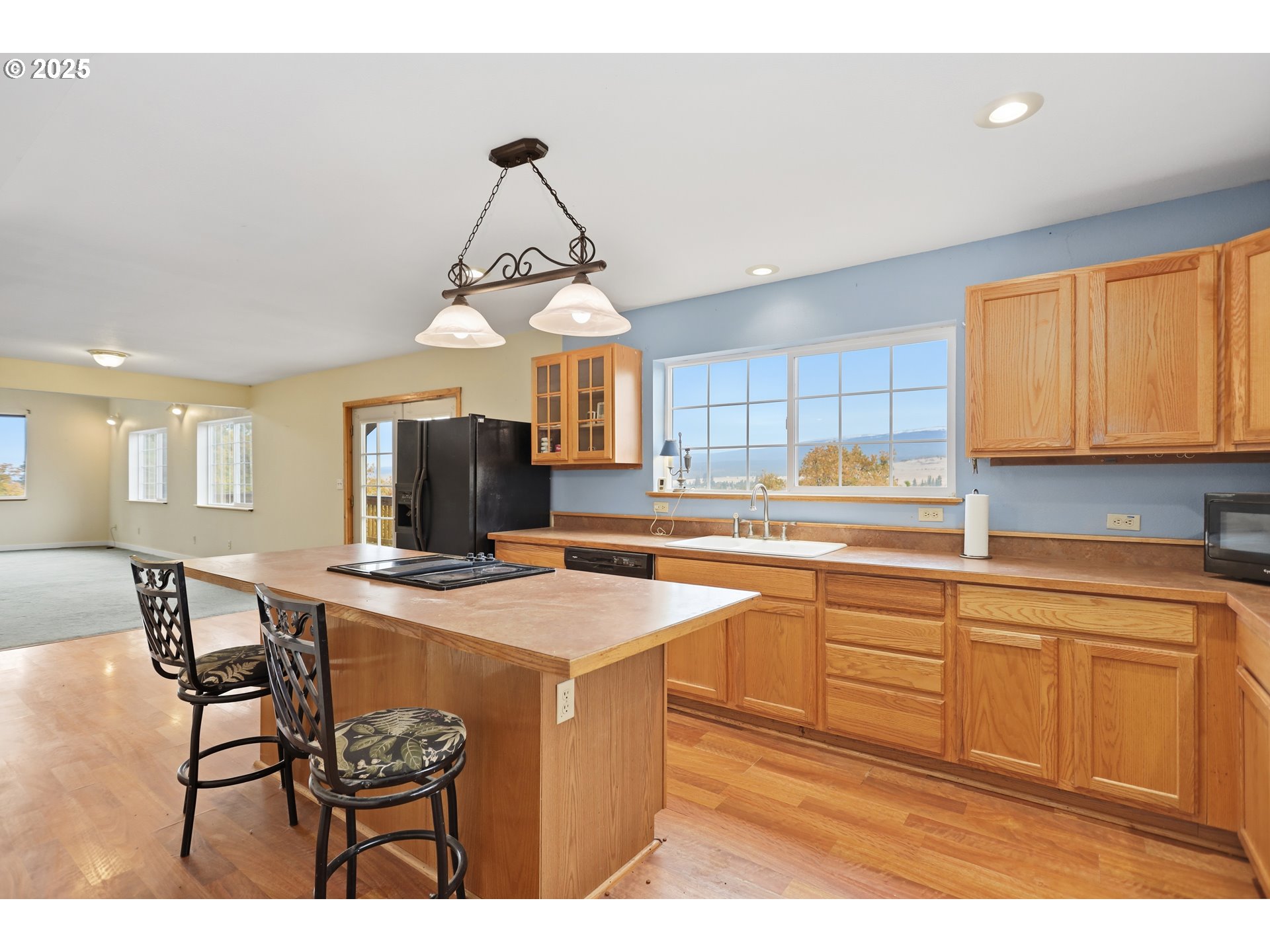 2224 Foster Place Goldendale, WA 98620 - Photo 17 of 45 a kitchen with stainless steel appliances granite countertop a sink a stove a dining table and chairs