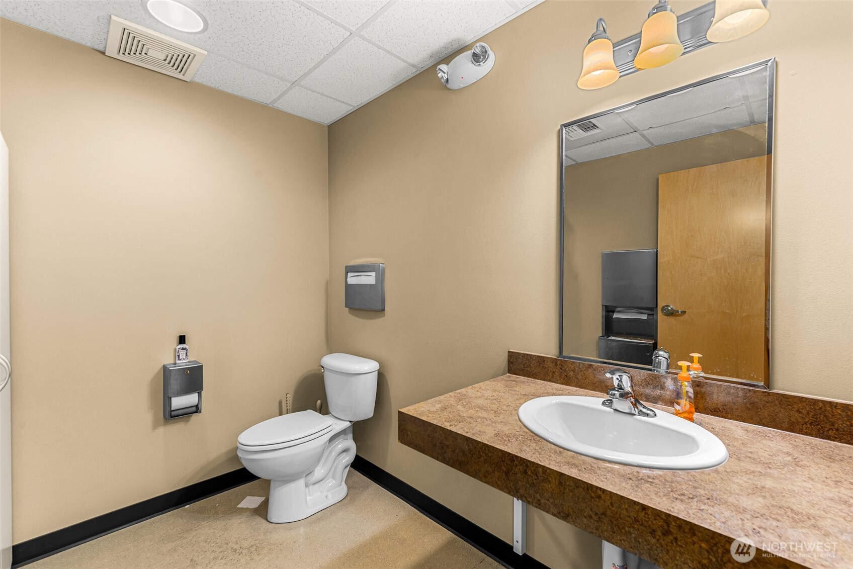 10 North Chelan Avenue Wenatchee, WA 98801 - Photo 33 of 40 a bathroom with a granite countertop sink a large mirror and a toilet