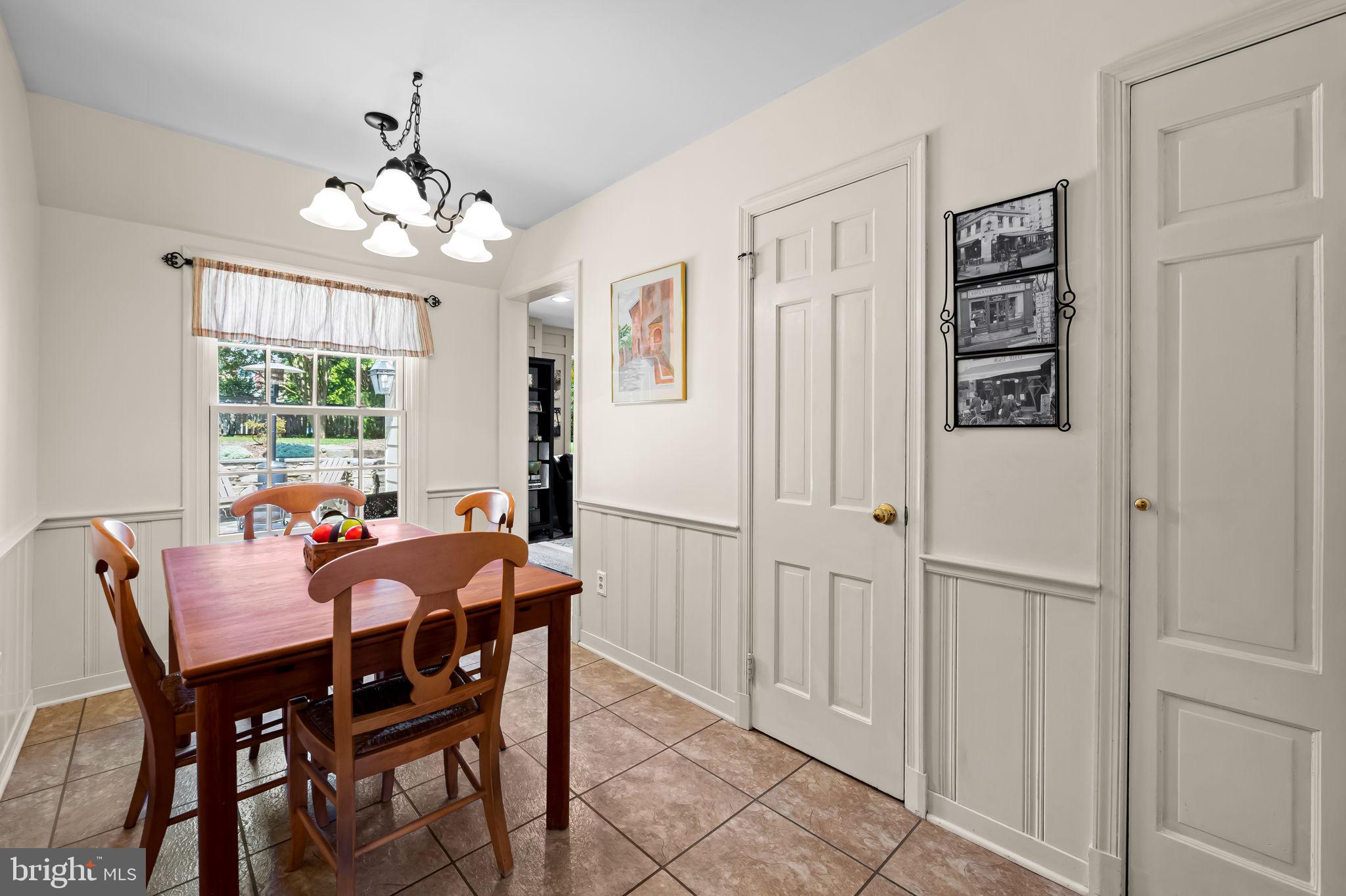 608 Worcester Road Baltimore, MD 21286 - Photo 14 of 49 a dining room with furniture a chandelier and a window