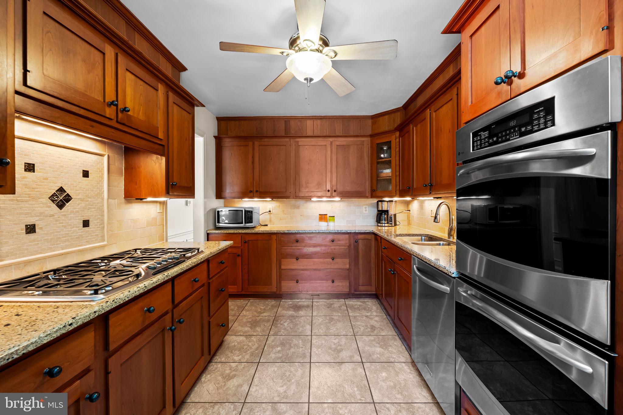 608 Worcester Road Baltimore, MD 21286 - Photo 16 of 49 a kitchen with stainless steel appliances granite countertop a stove and cabinets