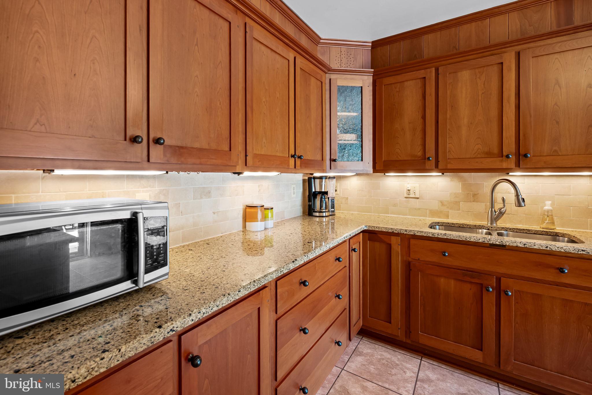 608 Worcester Road Baltimore, MD 21286 - Photo 17 of 49 a kitchen with stainless steel appliances granite countertop a sink a stove and cabinets