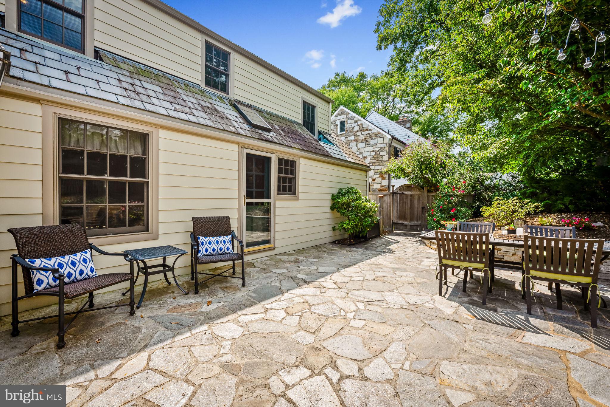 608 Worcester Road Baltimore, MD 21286 - Photo 20 of 49 a view of a patio with a dining table and chairs with wooden fence