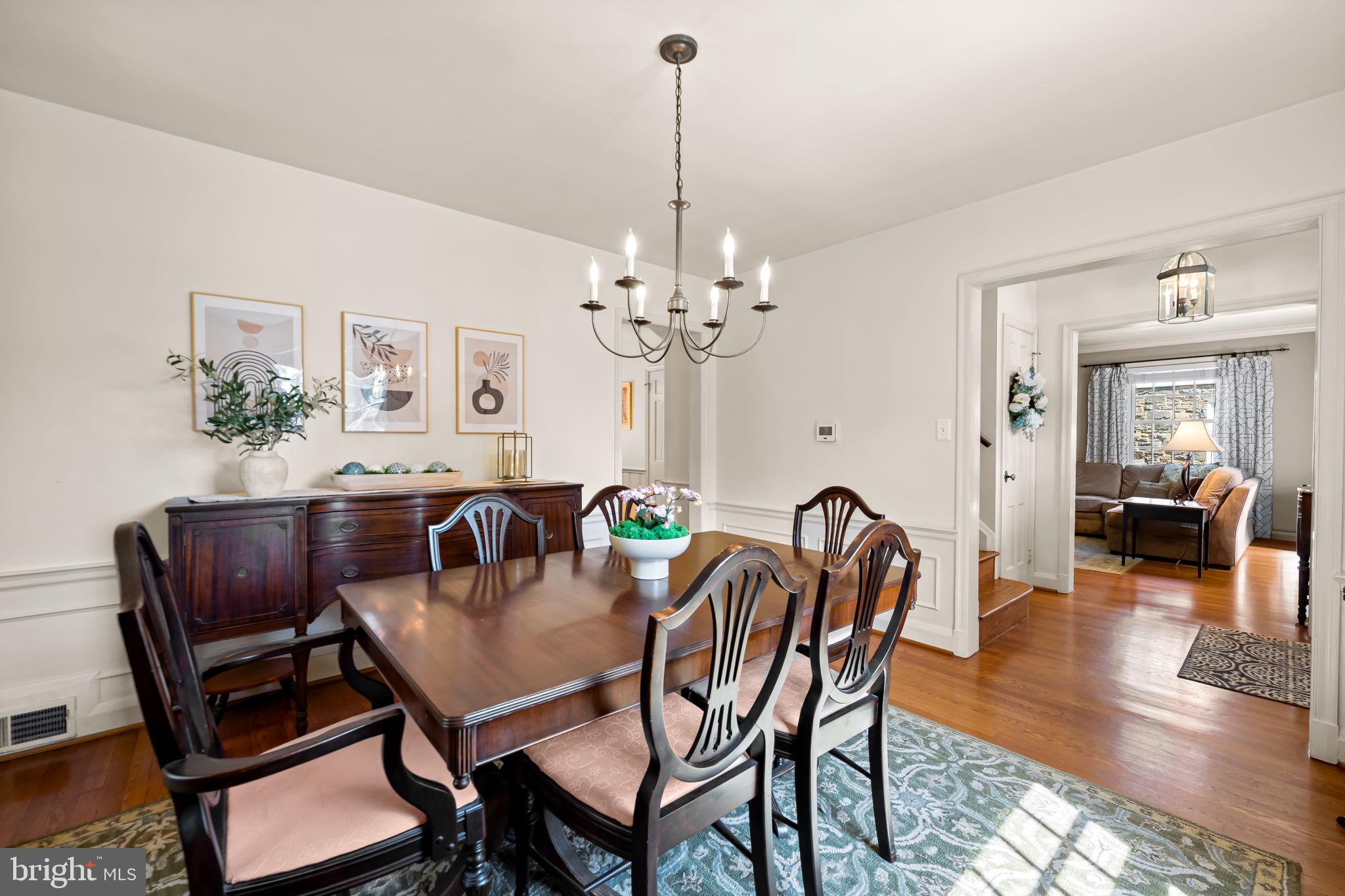 608 Worcester Road Baltimore, MD 21286 - Photo 22 of 49 a dining room with furniture a chandelier and wooden floor