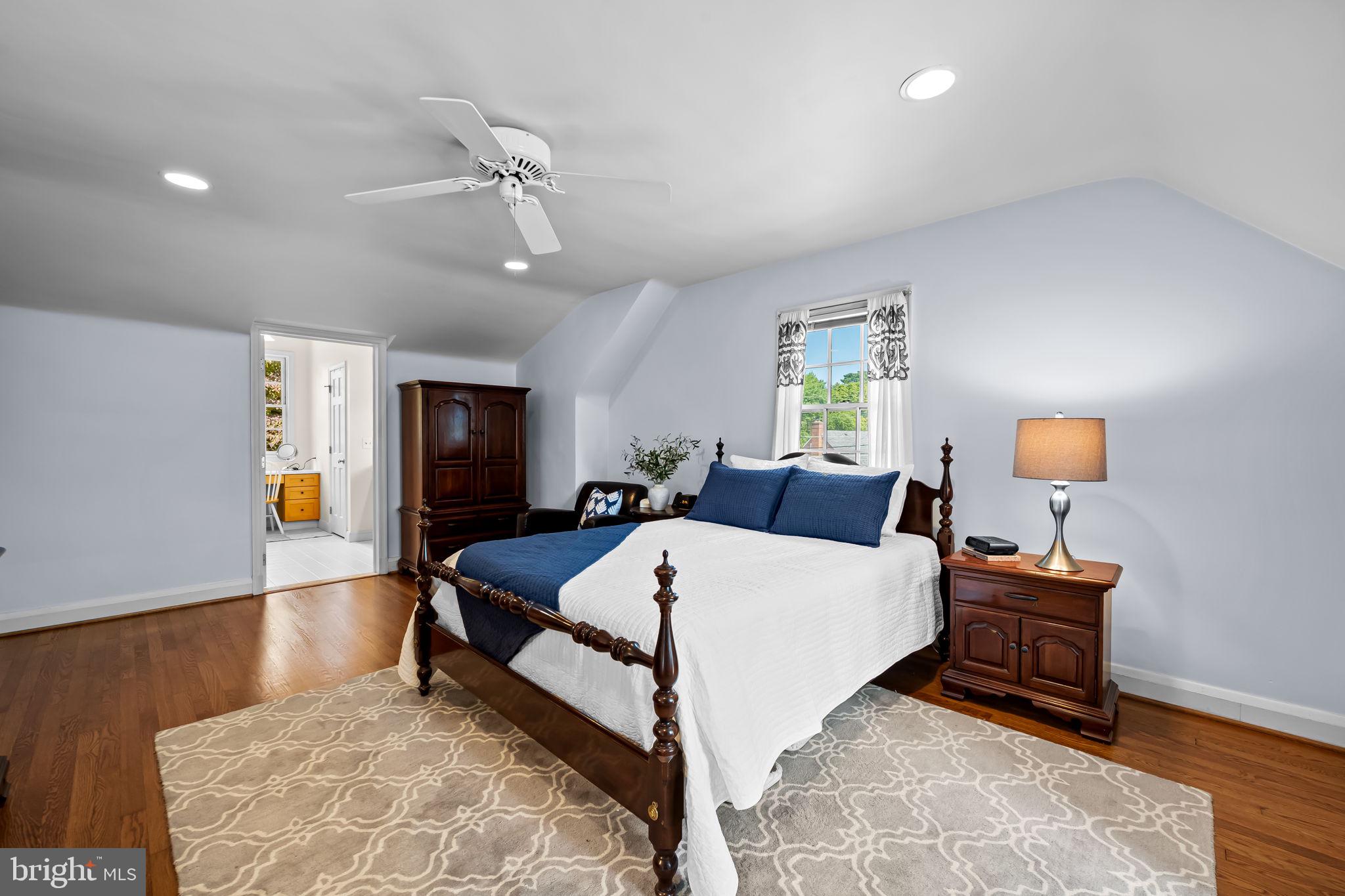 608 Worcester Road Baltimore, MD 21286 - Photo 27 of 49 a large bedroom with a bed and wooden floor