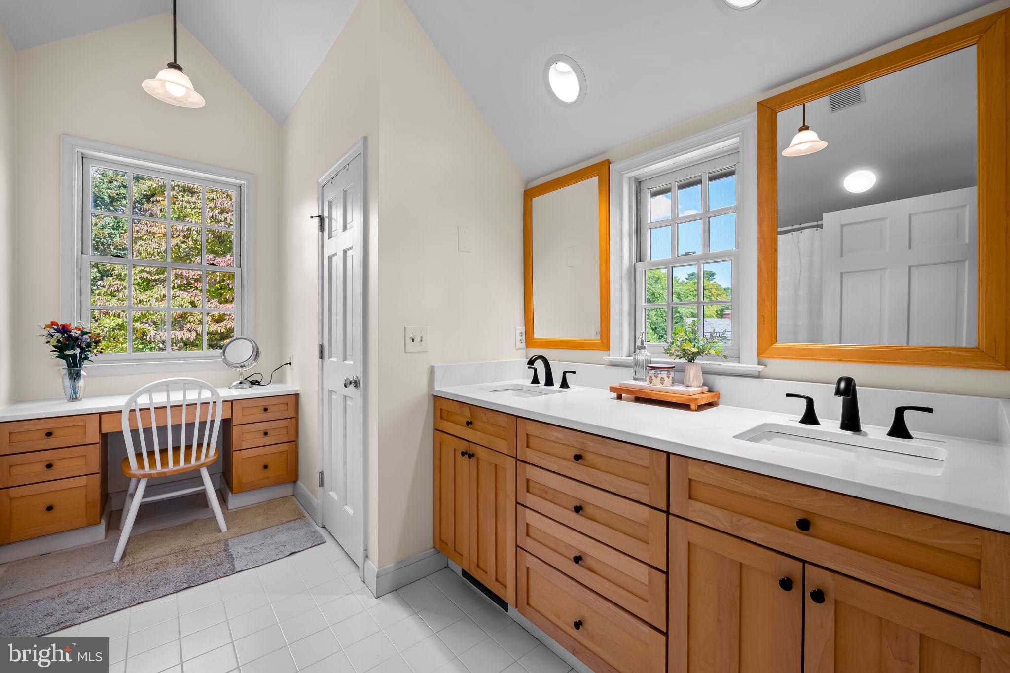 608 Worcester Road Baltimore, MD 21286 - Photo 28 of 49 a spacious bathroom with a double vanity sink large mirror and next to a window
