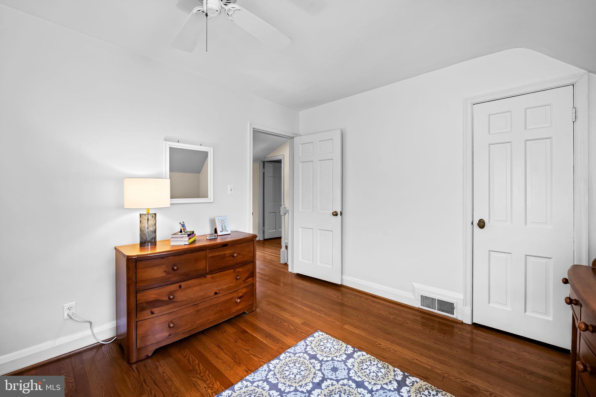 608 Worcester Road Baltimore, MD 21286 - Photo 31 of 49 a room with a bed and wooden floor