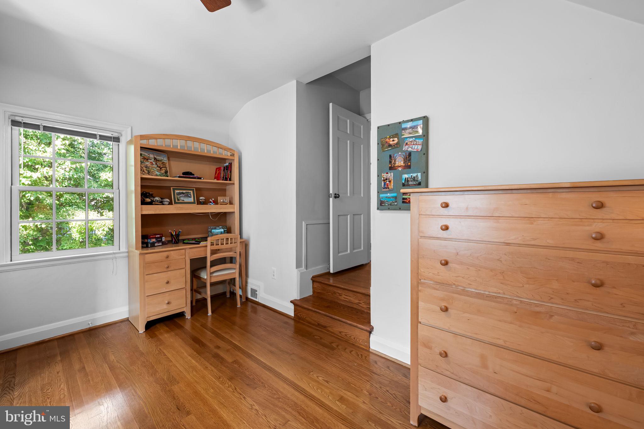 608 Worcester Road Baltimore, MD 21286 - Photo 35 of 49 a view of a bedroom with wooden floor and cabinet