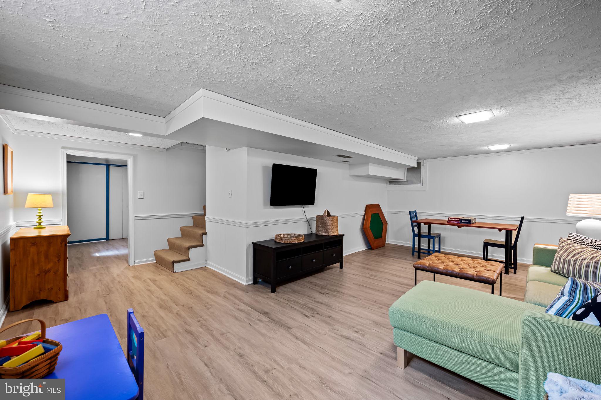 608 Worcester Road Baltimore, MD 21286 - Photo 38 of 49 a living room with furniture and a flat screen tv