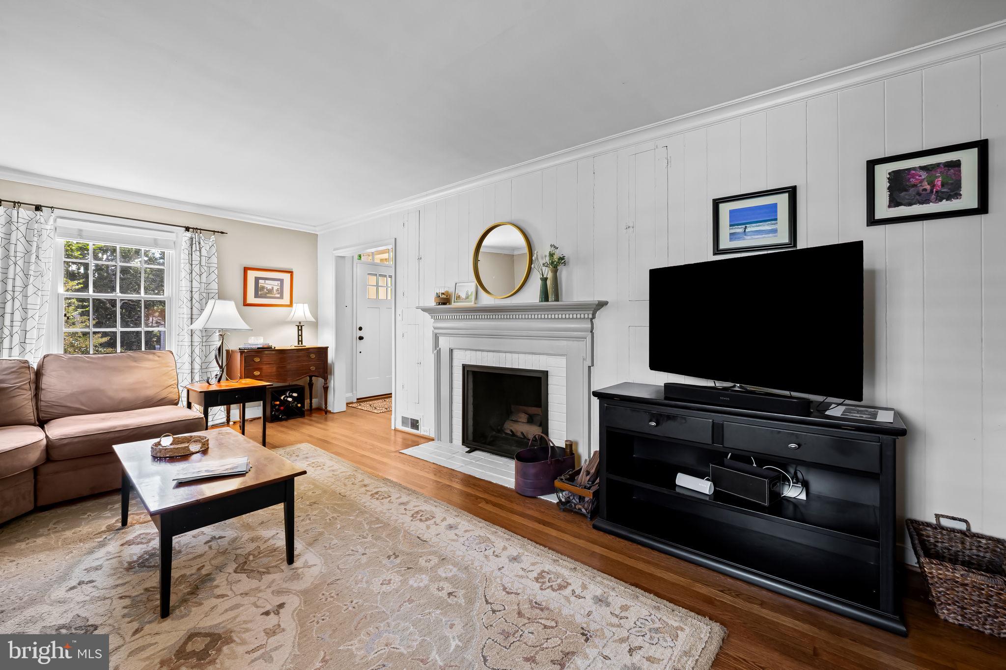 608 Worcester Road Baltimore, MD 21286 - Photo 9 of 49 a living room with furniture a flat screen tv and a fireplace