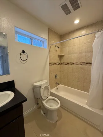 a bathroom with a toilet a sink and bathtub