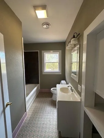 a room with a window a washer and dryer