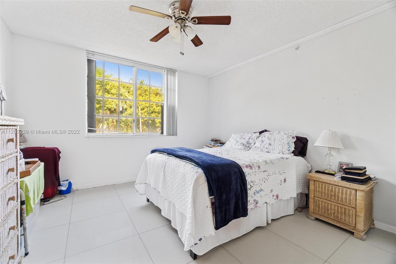 2071 Renaissance Boulevard, Unit 203 Miramar, FL 33025 - Photo 12 of 17 a bedroom with a bed and a window