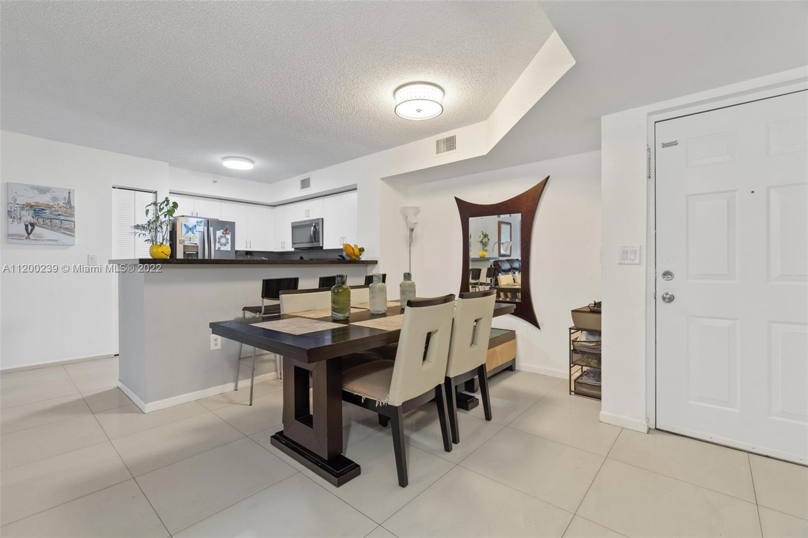 2071 Renaissance Boulevard, Unit 203 Miramar, FL 33025 - Photo 3 of 17 a dining room with furniture and window