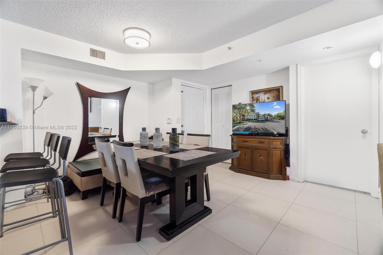 2071 Renaissance Boulevard, Unit 203 Miramar, FL 33025 - Photo 5 of 17 a view of a dining room with furniture