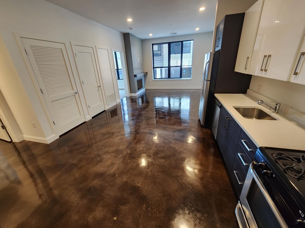 22 Mechanic Street, Unit 507 Quincy, MA 02169 - Photo 2 of 21 a kitchen with a sink appliances and cabinets