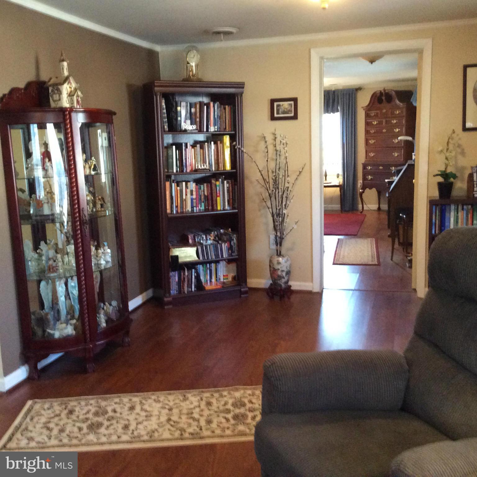 229 Baltimore Street Aberdeen, MD 21001 - Photo 11 of 24 a living room with furniture and a book shelf